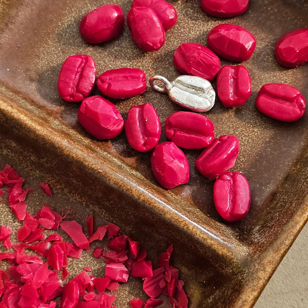 Coffee Beans made from jewelers wax and one made from sterling silver at the center of the dish