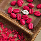 Coffee Beans made from jewelers wax and one made from sterling silver at the center of the dish